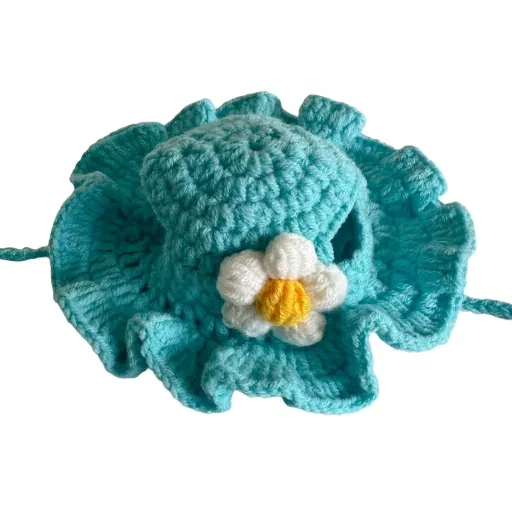 Teal hat with a white-and-yellow flower
