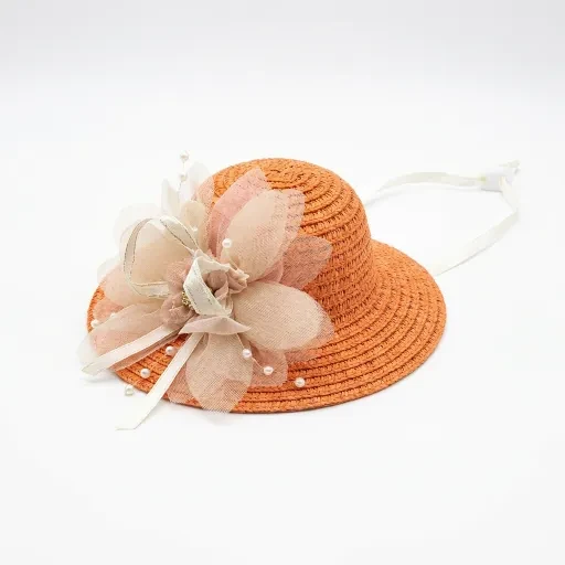 Orange hat with pale flowers and ribbon