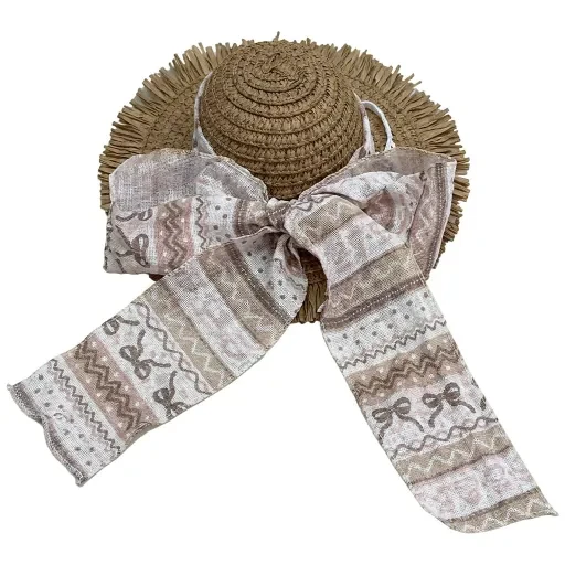 Hat with a large gray patterned bow and fringed brim